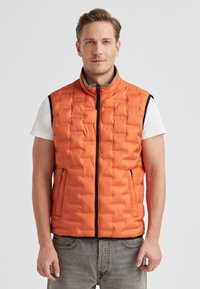Orange puffer vest with a quilted design, front zipper, and side pockets. Features a contrasting black zipper and green collar lining.
