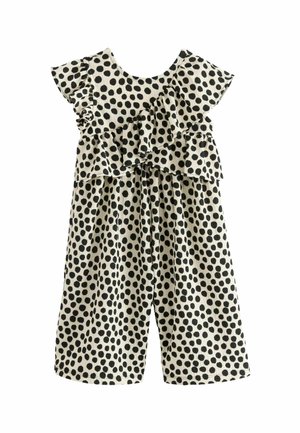 Weißer ärmelloser Overall mit schwarzen Polka-Dots, diagonal verlaufender Rüschenschicht oben und weitem Bein.
