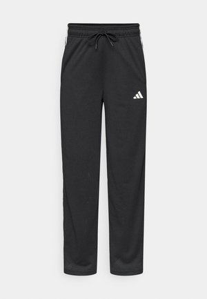 Czarne sportowe spodnie z siateczki z elastycznym paskiem w talii, sznurkiem oraz białym logo po lewej stronie. Posiadają boczne kieszenie i prosty krój nogawek.