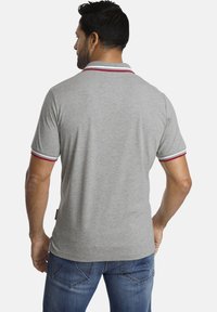 Graues Poloshirt mit kurzen Ärmeln, ausgestattet mit einem rot-weißen gestreiften gerippten Kragen und Ärmeln, aus einem weichen Baumwollmischgewebe gefertigt.