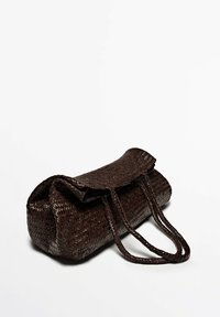 Woven dark brown bag with a rounded shape, flat top flap, and two long braided handles. Visible texture from woven material.