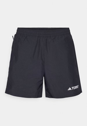 Black athletic shorts made from lightweight fabric, featuring an elastic waistband, side pockets, and a white logo on the bottom right.