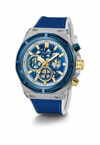 Blaues Chronograph-Uhr mit silbernen und goldenen Akzenten, ausgestattet mit einem strukturierten blauen Armband, einem achteckigen Gehäuse und einem komplexen Zifferblatt-Design mit mehreren Unterzifferblättern.