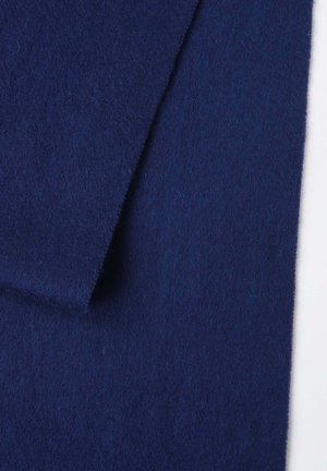 Navy blue wool felt fabric with a smooth, soft texture, showing folds and subtle variations in color under light.