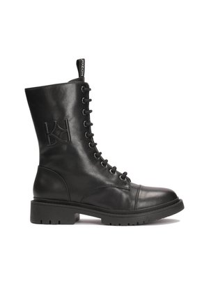 Black leather ankle boot with lace-up design, rounded toe, and thick rubber sole. Features embossed logo on the side and pull tab.