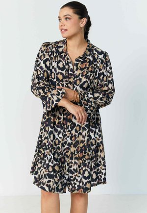 Leopard print shirt dress with long sleeves, button front, and tiered skirt. Fabric has a smooth texture in shades of brown, cream, and black.