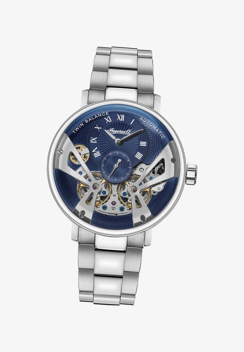 Roestvrijstalen automatische horloge met een blauwe wijzerplaat, zichtbare uurwerken en zilveren accenten. Voorzien van Romeinse cijfers en een gestructureerde wijzerplaat.