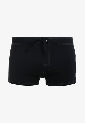 Black swim shorts with a drawstring, featuring a logo on the left side. The material is smooth with a fitted design and contrasting stitching.