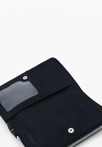 Black fabric wallet open, showing multiple card slots, a mesh ID window, a snap button pocket, and a zipper along the edge.