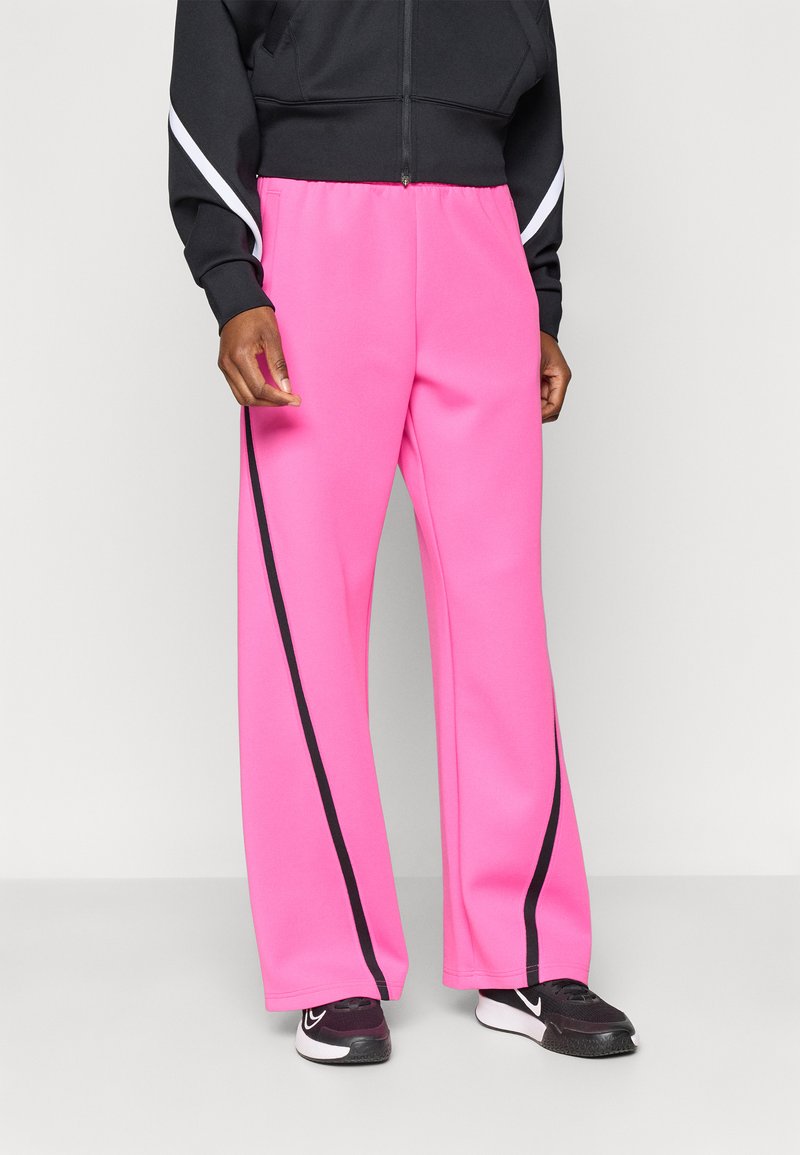 Ροζ παντελόνι φόρμας με φαρδύ πόδι και μαύρη ρίγα στο πλάι, κατασκευασμένο από απαλό ύφασμα, με ελαστική μέση και άνετη εφαρμογή.