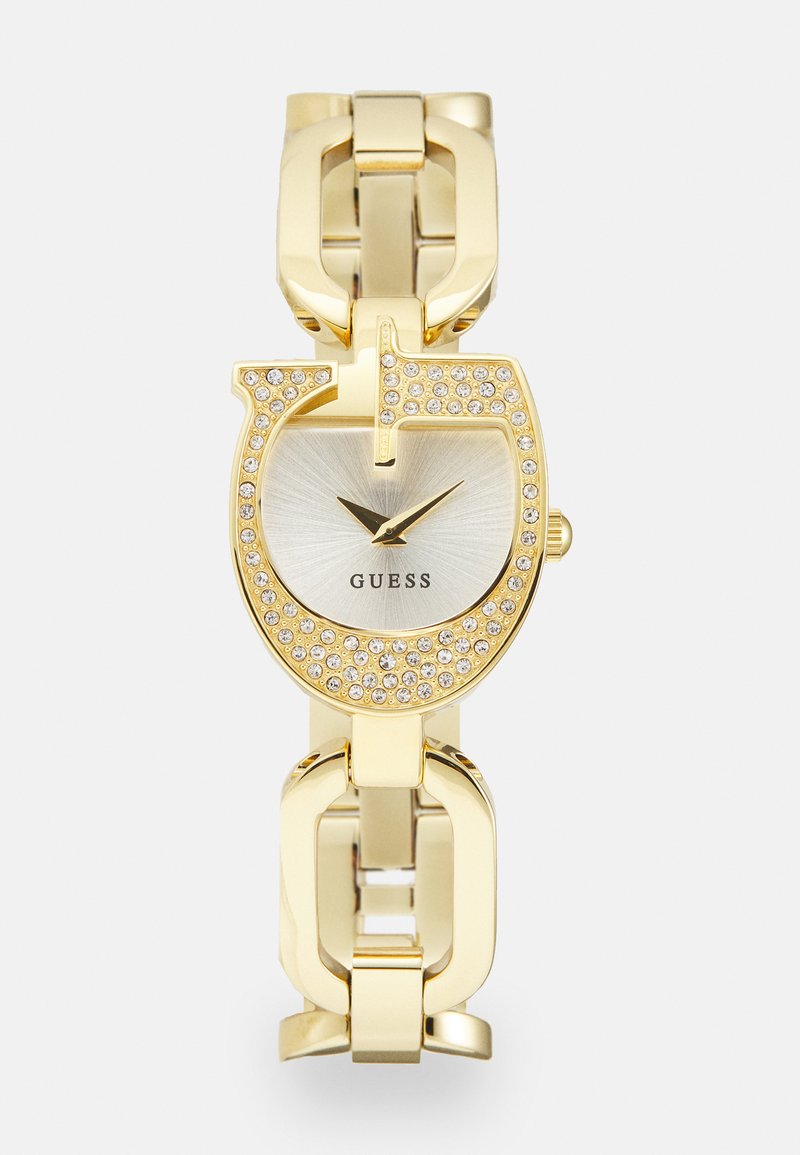 Gold metal watch with a round face, silver dial, minimalist hour markers, and embedded rhinestones in a unique shape bracelet design.
