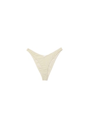 Slip bikini in tessuto beige a coste con aperture laterali alte e vita bassa su sfondo bianco.