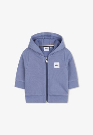 Sweat à capuche zippé bleu en coton doux, avec un petit écusson logo blanc sur la poitrine gauche et des poignets et ourlet côtelés.