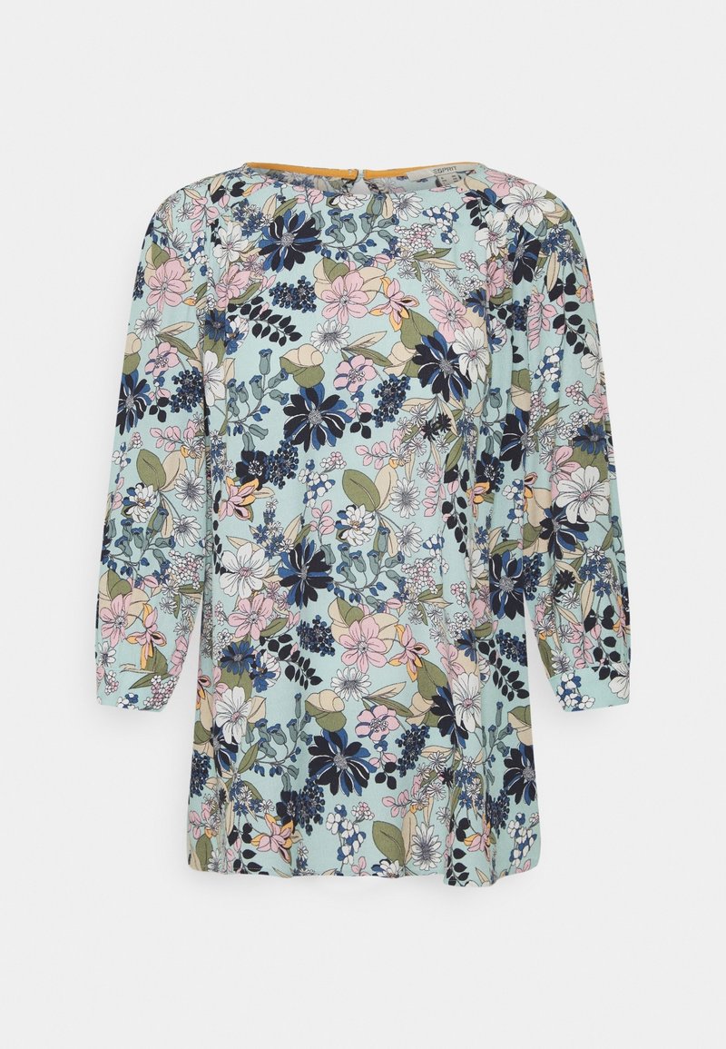 Tunique fleurie à manches longues en bleu clair, ornée de diverses fleurs colorées, de feuilles vertes, et d'une ouverture en forme de goutte au dos.