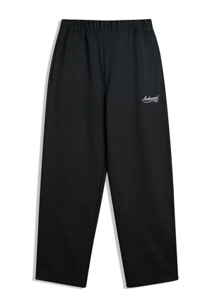 Black, loose-fit sweatpants with an elastic waistband, side pockets, and small white logo accent on the left thigh. Textured fabric.