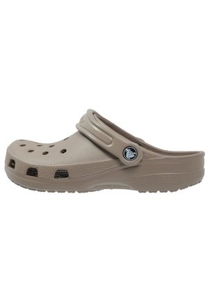 Beige lightweight clog with ventilation holes, raised edges, and a strap. Made of durable material with a textured surface and logo detail.