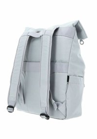 Sac à dos en tissu gris avec deux bretelles rembourrées, une fermeture à enroulement, des poches latérales et une base renforcée. Texture lisse, design moderne.