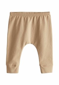 Pantaloni in cotone color camoscio con vita elastica, vestibilità ampia e polsini a coste. Caratterizzati da un design arrotondato con cavallo basso per maggiore comfort.