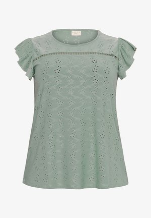 Svijetlozelena košulja kratkih rukava s volanima, koja ima izrezane detalje u broderie anglaise tehnici i strukturirani izrez. Mekani, teksturirani materijal.