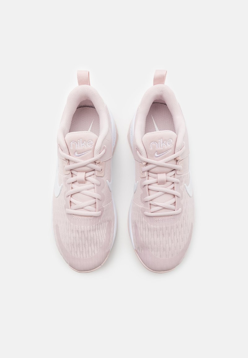 Baskets de sport roses clairs avec tige en tissu en maille, fermeture à lacets, col rembourré et accents blancs du logo. Semelle intermédiaire rembourrée pour le confort.