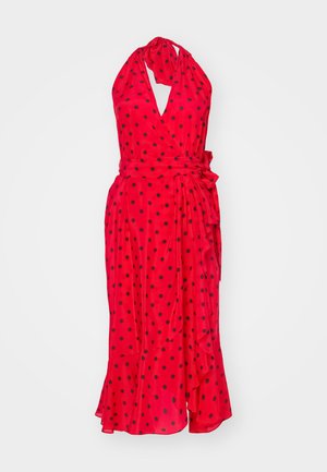 Red sleeveless wrap dress with black polka dots, tie waist, flared hem, and deep V-neckline, made of lightweight fabric.