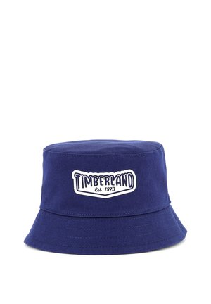 Marineblauwe katoenen bucket hat met een brede, gestikte rand en een witte Timberland-logo patch met de tekst "Est. 1973".