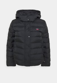 Black puffer jacket with a hood, featuring a quilted design, snap buttons, and a small red Levi's logo on the left chest. Soft texture.