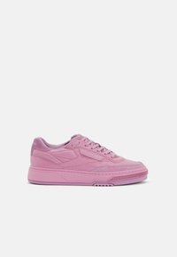 Pink sneaker with smooth leather and synthetic upper. Features lace closure, padded collar, thick midsole, and textured rubber outsole.