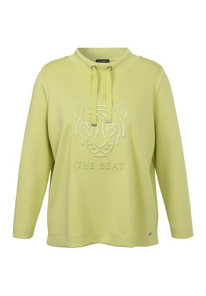 Lichtgroene trui met lange mouwen, een trekkoordkraag en een reliëf van een tijgersneus en de tekst "THE BEAT" op de borst.
