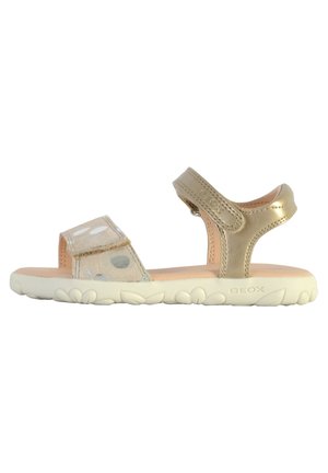 Sandalias doradas con una correa texturizada, con lunares y cierres de Velcro ajustables. Suela ligera con un diseño floral para mayor tracción.
