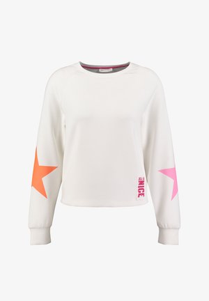 White sweatshirt with long sleeves featuring large orange and pink star designs on the sleeves and a "Just Be Nice" print on the hem.