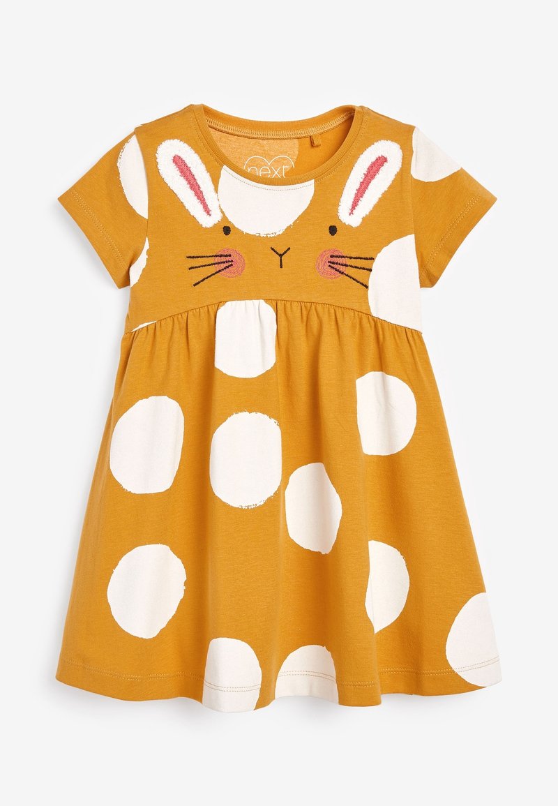 Robe en coton jaune avec un motif de visage de lapin, manches courtes et pois blancs. Jupe froncée et encolure ronde.
