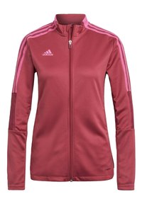 Chaqueta deportiva rosa con un alto cuello, cremallera completa y tres rayas rosas en cada brazo. Confeccionada con una tela suave y elástica con detalles de ventilación.