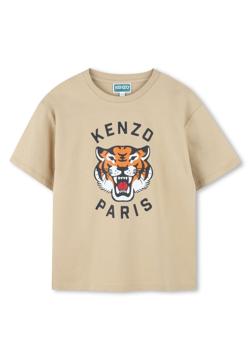 T-shirt in cotone beige con una grafica di una tigre in arancione e nero, con "KENZO" sopra e "PARIS" sotto in grassetto nero. Maniche corte.