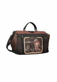 Borsa a tracolla marrone e nera con un design grafico che raffigura una ragazza vicino alla Torre Eiffel, lati trapuntati e manici per il trasporto doppi.