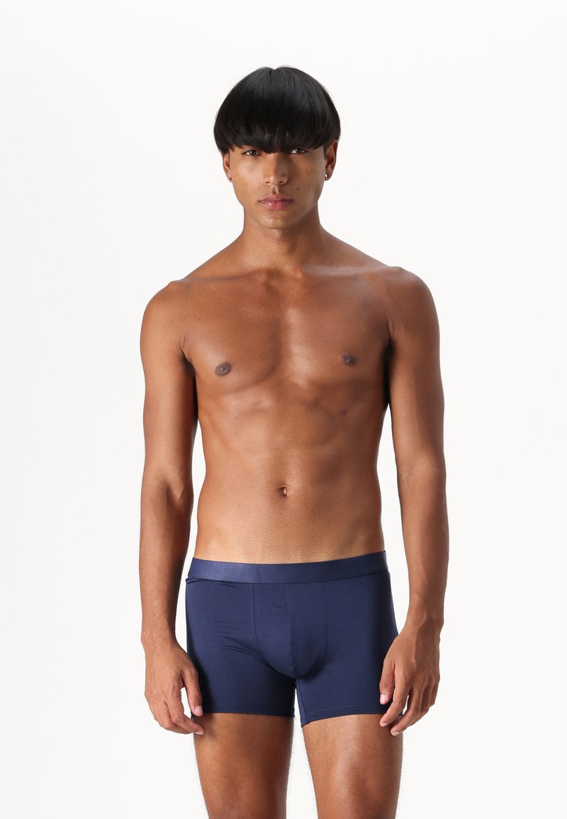 Navy blue boxer briefs made of smooth fabric with a fitted design and an elastic waistband. No visible patterns or graphics.