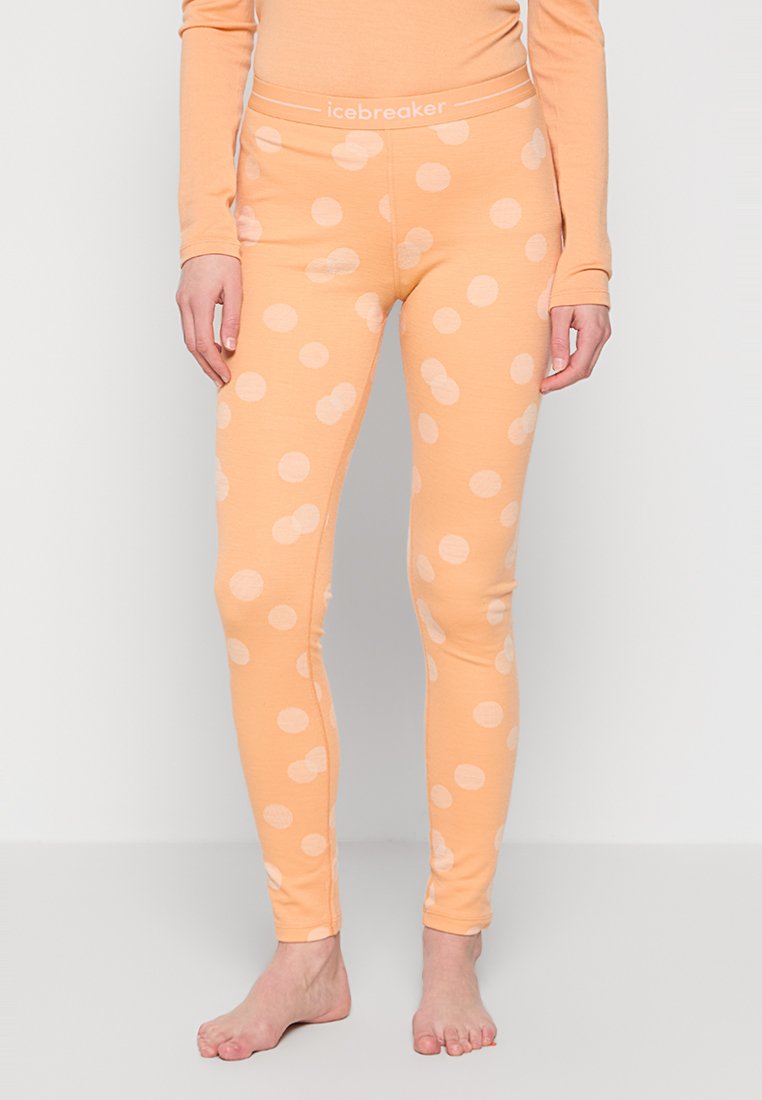 Pfirsichfarbene Leggings mit weißen Punkten, aus weichem Stoff, mit einem elastischen Bund. Eng anliegendes Design, das bis zu den Knöcheln reicht.