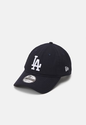 Navy baseball cap with white embroidered "LA" logo, adjustable strap, curved visor, and no visible patterns or accents.