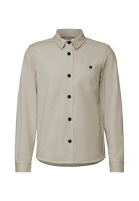 Camisa de manga larga beige hecha de una tela texturizada, con una botonera en la parte delantera, botones negros y un bolsillo en el pecho con solapa.