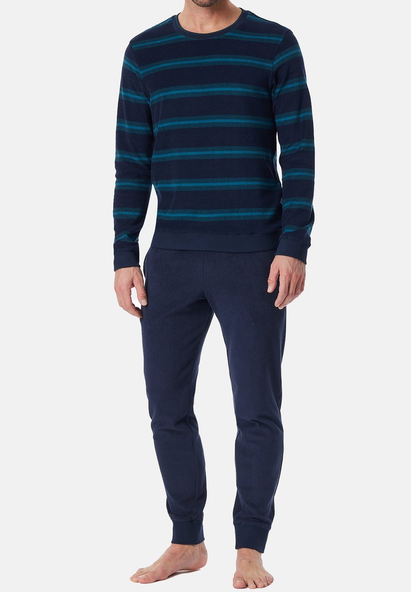 Navy blue cotton sweater with turquoise horizontal stripes, round neckline, and long sleeves; paired with navy cotton joggers featuring ribbed cuffs.