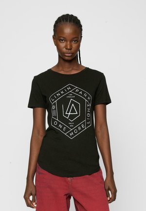 Black cotton t-shirt featuring a white geometric graphic with "Linkin Park" and "One More Light" text. Short sleeves, rounded neckline.