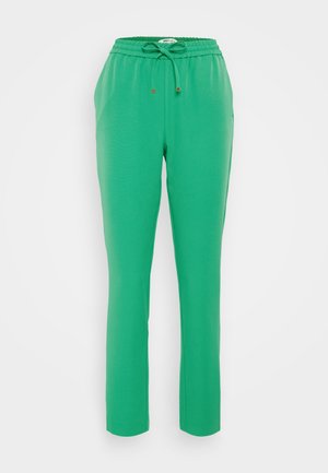 Grønne joggebukser med elastisk midje, snor, sidelommer og innsnevret bendesign. Jevn, lett tøy tekstur.