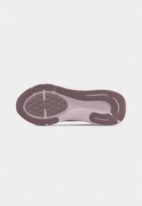 Shoe sole in light pink and brown with textured grip and tread patterns, displayed flat on a white background.