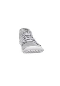 Light gray sneaker with a mesh upper, rounded toe, and elastic laces. White rubber sole with textured grip patterns. Flexible design.