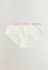 Slip in cotone avorio con vita in morbido elastico rosa, caratterizzata dal nome del marchio "NEXT" ripetuto in lettere maiuscole.