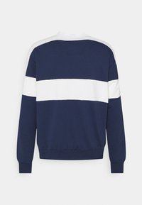 Mörkblå sweatshirt med vita horisontella ränder, rund halsringning och ribbade muddar. Mjukt bomullsmaterial, avslappnad passform, ingen synlig logotyp.