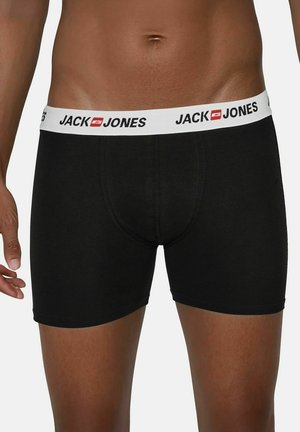 Boxer-briefs noirs avec une ceinture élastique blanche portant l'inscription "JACK & JONES" en noir. Texture lisse, design ajusté.