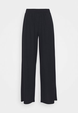 Zwarte wide-leg broek met elastische tailleband, gemaakt van gestructureerde stof, plat gelegd op een witte achtergrond.