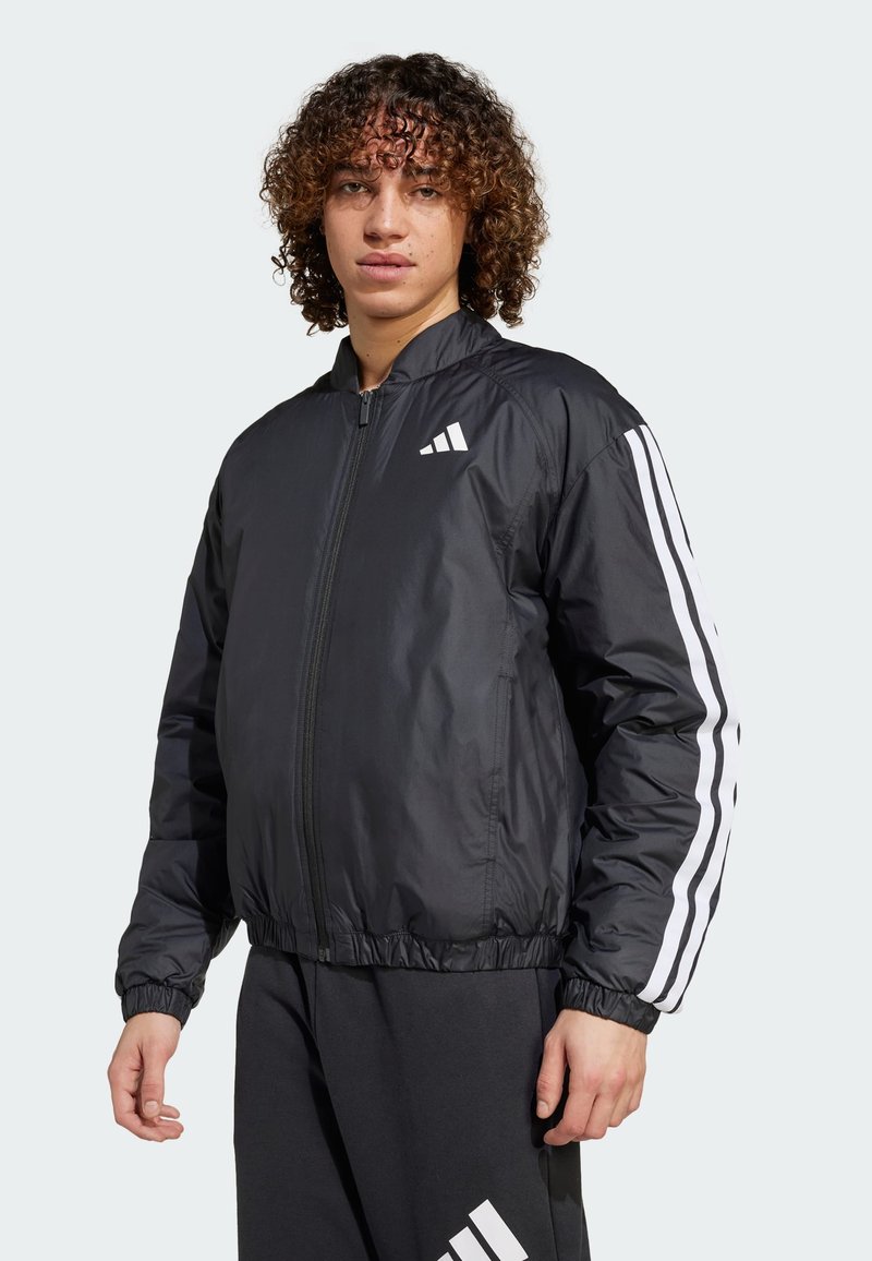 Melna bomber jakas ar rāvējslēdzēju, elastīgu jostu un aprocēm. Ar baltām svītrām uz piedurknēm un baltu logotipu uz krūšu.