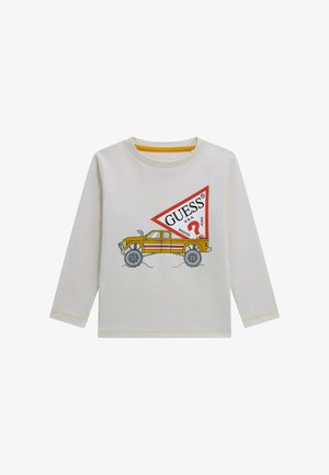 Lichtgrijs katoenen shirt met lange mouwen, met een geel-rode afbeelding van een vrachtwagen en het "GUESS"-logo met een vraagteken duidelijk zichtbaar.